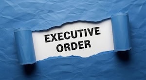 A torn blue paper with "EXECUTIVE ORDER" text on white background.
