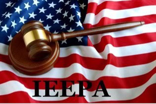 Gavel on American flag representing trade and legal authority.