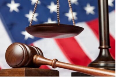 Legal scales and gavel in front of US flag for law firm SEO.