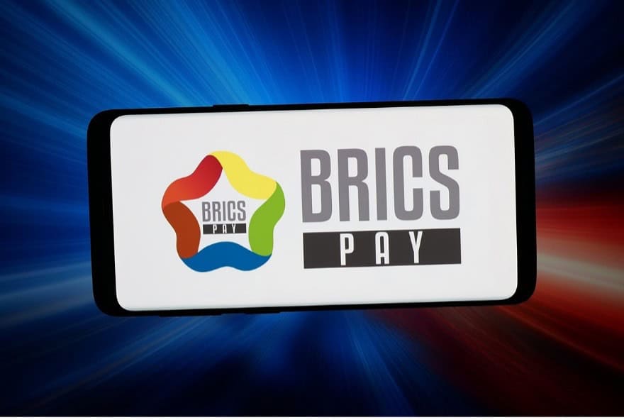 BRICS Pay logo on a smartphone screen with dynamic background.