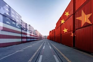 Shipping containers with US and China flags representing trade tariffs.